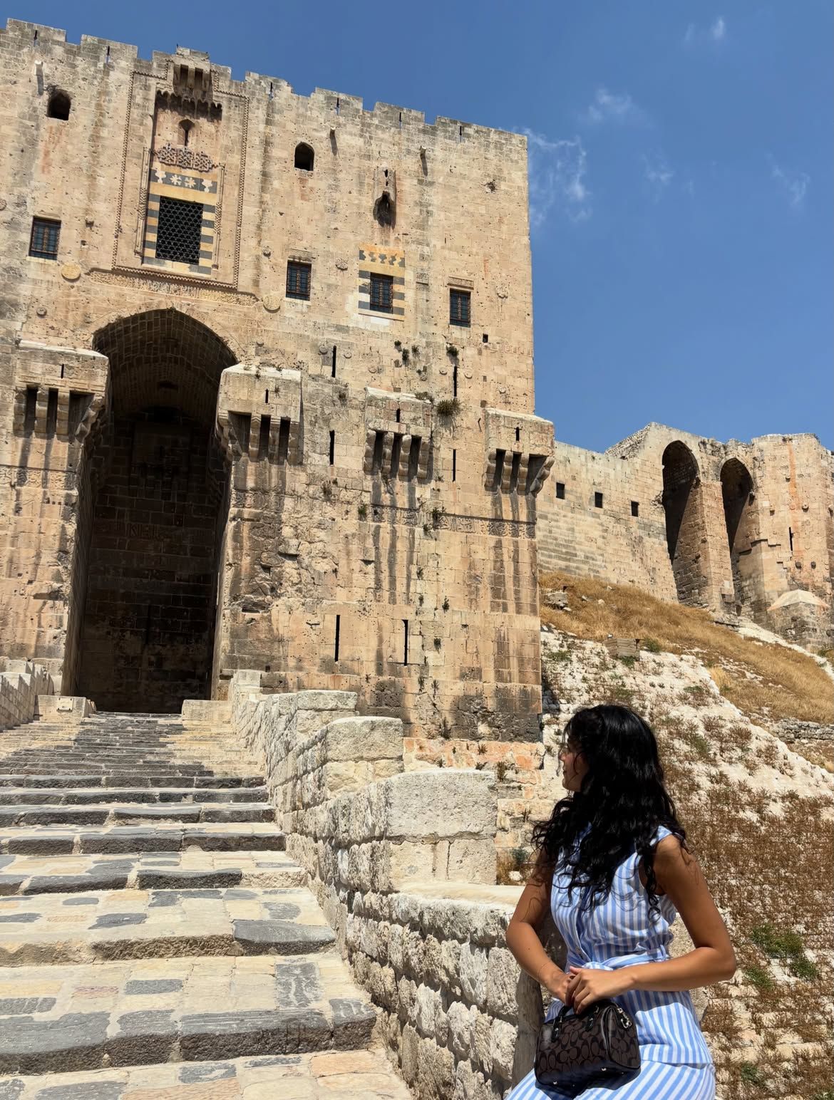 Lamar at the stone steps of the Citadel of Aleppo